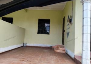 an empty room with a yellow wall and a window at Homestay Kota, Kuala Terengganu FREE WIFI in Kuala Terengganu