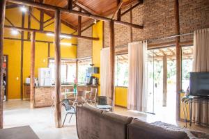 a living room with a couch and a dining room at Casa das Pedras in Lagoa Santa