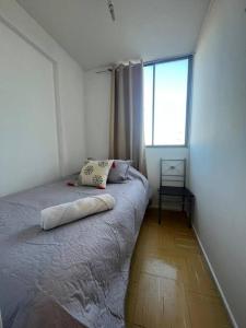 a bed in a room with a large window at Departamento equipado 338 Ovalle in Ovalle