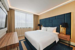 a hotel room with a large bed and a television at Radisson Blu Szczecin in Szczecin