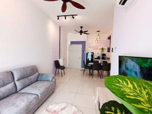 a living room with a couch and a dining room at The Horizon Ipoh 2BR L12 by Grab A Stay in Ipoh
