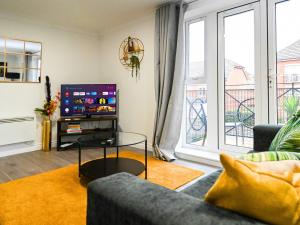 a living room with a couch and a tv at Golden King Suite - Balcony & FREE Parking - Central Bedford in Bedford