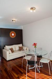 ein Wohnzimmer mit einem weißen Sofa und einem Glastisch in der Unterkunft Cabello trendy in Buenos Aires