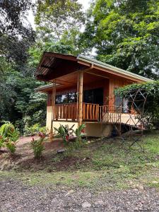 a small house with a porch and a deck at Gambas Lodge in Fortuna