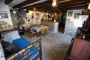 a bedroom with a table and a dining room at Holiday Home Kvarantan in Veliki Drvenik