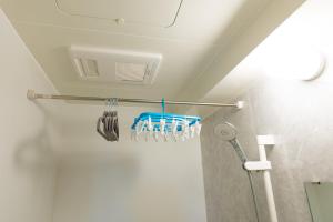 a bathroom with a rack with tooth brushes at GANADAN天文館 in Kagoshima