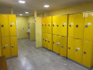 a row of yellow lockers in a locker room at Big Hostel in El Bolsón