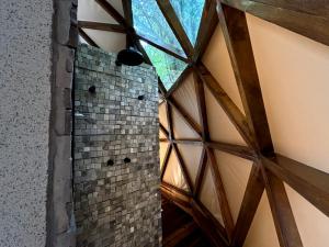 a shower in a building with a window at Domo Vila da Serra in Nova Lima