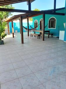 a patio with benches and a blue building at casa do serramar in Rio das Ostras