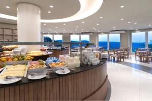 a buffet line in a hotel with food on it at Apartamento no Golden Resort Laghetto in Gramado