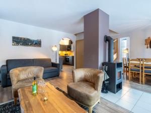 a living room with a couch and a table and chairs at Landal Bad Kleinkirchheim in Bad Kleinkirchheim