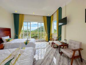 a hotel room with two beds and a balcony at Summer Resort in Kep