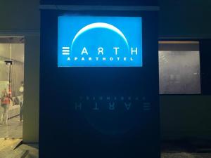 a blue sign for an art exhibit in a building at Earth Inn in Chennai