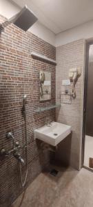 a bathroom with a sink and a shower at Earth Inn in Chennai