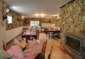 a dining room with tables and a stone wall at Safir przy samym WYCIĄGU in Karpacz
