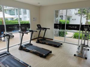 a gym with several cardio machines in a room at Courtyard Khaoyai By SW in Mu Si