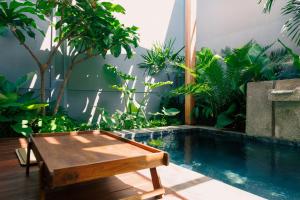 einen Hinterhof mit einem Pool, einem Tisch und Pflanzen in der Unterkunft Mamori House at Kohlarn in Ko Larn
