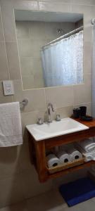 y baño con lavabo, espejo y toallas. en CASITA DE ANELÉ en San Carlos de Bariloche