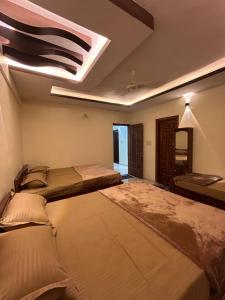a room with three beds and a skylight at AL-MANAL 305 Premium Room 5 beds in Bhatkal