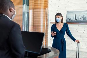a woman in a blue dress wearing a face mask at Sheraton Tribeca New York Hotel in New York