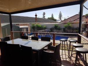 a patio with a table and chairs on a deck at Spacious self contained unit - short walk to Grange Jetty in Grange