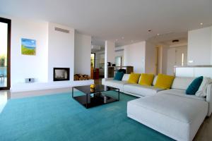 a living room with a white couch and yellow pillows at Deluxe Villa Jante Infinity Pool in Durrës