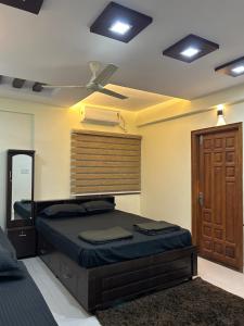 a bedroom with a bed and a ceiling fan at AL-MANAL 304 premium Room 5Beds in Bhatkal