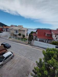 a view of a street with houses and a car at Pousada Vista da Lagoa in Florianópolis