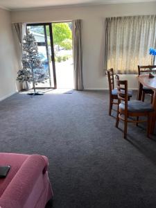 a room with a table and chairs and a dining room at Stay with Benny in Nelson