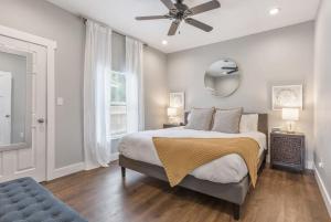 a bedroom with a bed and a ceiling fan at BOHO Bungalow in Tulsa