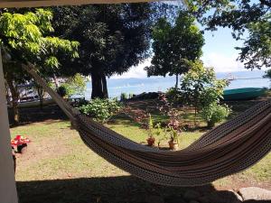 a hammock in a yard with a view of the ocean at Happy Monkeys in Puerto Jiménez