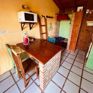 a small kitchen with a table and a microwave at June en el Uritorco in Capilla del Monte