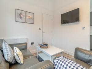 a living room with a couch and a table at The Nest in Bempton