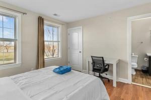 a bedroom with a bed and a desk and a desk at Corporate Housing MGM in Detroit
