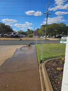 a puddle of water on the side of a road at Emerald Motel Apartments in Emerald
