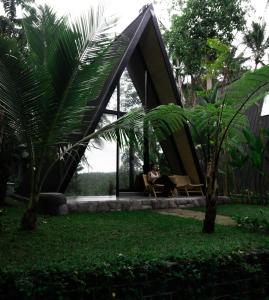 een persoon in een hangmat in een huis bij Delta Casa Ubud- Tiny Villas in Bali's Jungles in Gianyar