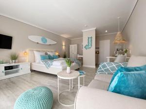 - un salon avec un canapé et une planche de surf sur le mur dans l'établissement Germania-22, à Sankt Peter-Ording