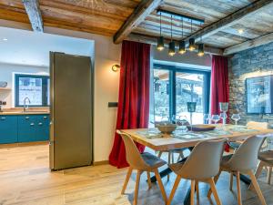 a kitchen and dining room with a table and chairs at Appartement Val-d'Isère, 5 pièces, 8 personnes - FR-1-694-345 in Val-d'Isère