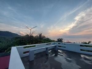 a white bench sitting on top of a roof at Kua's Pad Batangas Room in Lian
