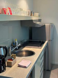 a kitchen with a sink and a counter top at Pandanas Apt 5 15th fl Darwin CBD Harbor views in Darwin