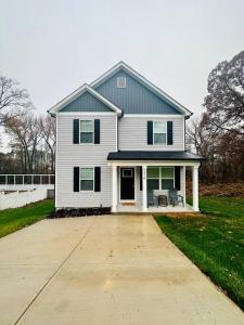 a white house with a driveway in front of it at SHARED HOUSE Bedroom for rent SEPARATELY Brand NEW Home! in Gastonia