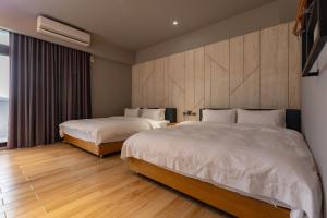 a hotel room with two beds and a window at Rainbow in Ji'an