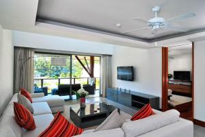 a living room with two white couches and a tv at Pearl of Naithon in Nai Thon Beach