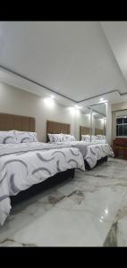 two beds in a room with a mirror at Oceanic,unit 124 ocean view in Durban