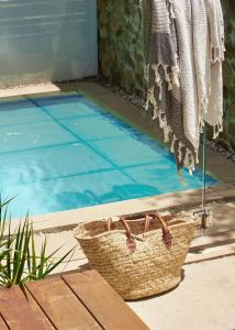 a basket sitting next to a swimming pool at Worrowing Jervis Bay in Huskisson