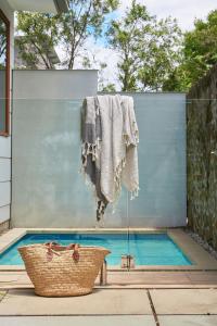 a towel hanging over a swimming pool with a basket at Worrowing Jervis Bay in Huskisson