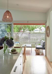 a kitchen with a large window and a table at Worrowing Jervis Bay in Huskisson