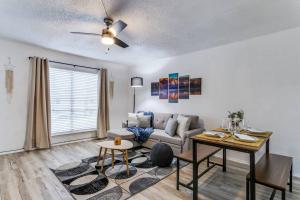 a living room with a couch and a table at Medical District_Fast Wi-fi in Dallas