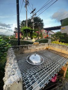 a metal grate with a bowl on top of it at เอนกายสบายรีสอร์ต in Ban Tha Nang Hom (1)