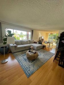 a living room with a couch and a table at Charming and Bright Apartment in Los Angeles